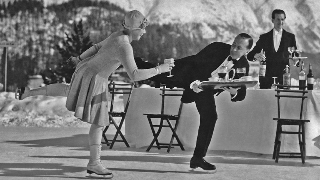 Circa 1925: Skating waiters serve drinks to guests on the ice rink at the Grand Hotel in St Moritz, Switzerland. (G. Riebicke/Archive Photos/Getty Images)