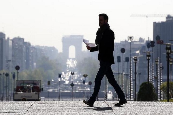 A businessman walks on the esplanade of La Defense, in the financial and business district west of Paris April 10, 2014. REUTERS/Gonzalo Fuentes