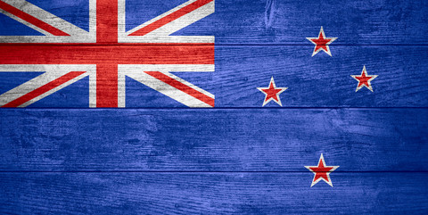 flag of New Zealand or banner on wooden background